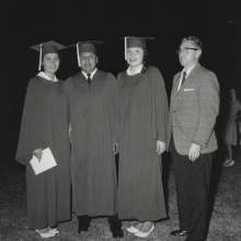  William D. Boehmer standing with Seminole graduates of Okeechobee High School in Okeechobee, Florida in their graduation caps and gowns. From left to right are Connie Johns, Jim Shore, Lorene Bowers, and William D. Boehmer, Community Services Officer.