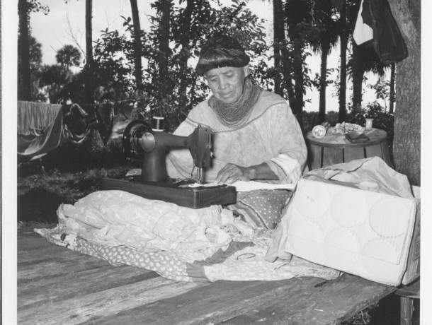 Jennie Tiger creating patchwork with a hand-crank sewing machine, circa 1960. ATTK 2009.34.1393