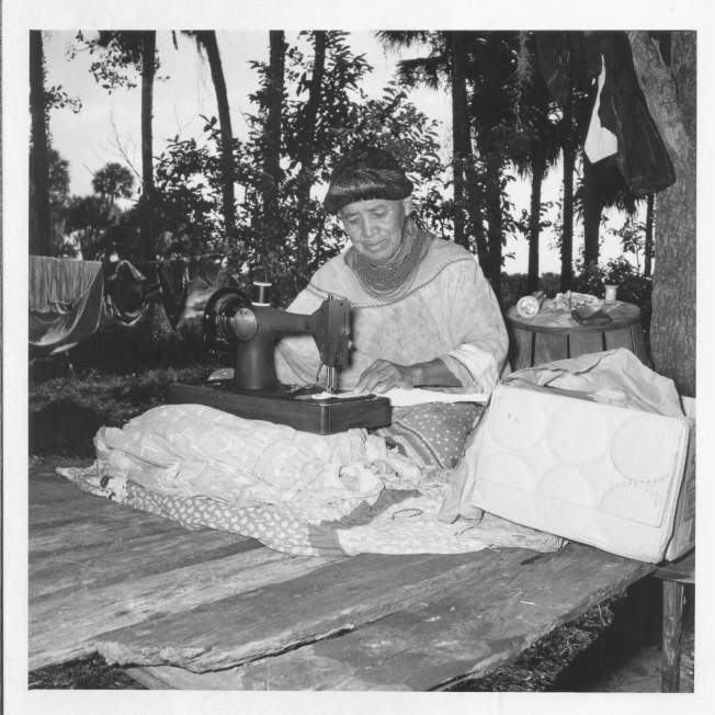 Jennie Tiger creating patchwork with a hand-crank sewing machine, circa 1960. ATTK 2009.34.1393