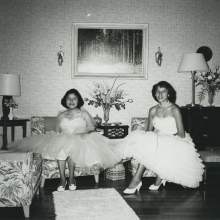  Geneva Shore and Edna Johns in formal gowns in the living room of the teacher's quarters on the Brighton Reservation. Both girls were graduates of Okeechobee High School in Okeechobee, Florida.