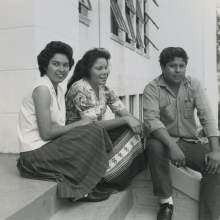 Connie Johns, Lorene Bowers and Jim Shore, graduates of Okeechobee High School in Okeechobee, Florida.  The three appear to be sitting on the front steps of the school.