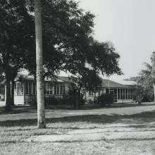  outside of the Brighton Indian Day School. The first school ever asked for by the Brighton Seminoles was built in 1938-39 using much Seminole labor. The school opened on January 9, 1939 with an enrollment of eight students. It closed in 1954 when Seminole children enrolled in Florida public school. A screened front porch and office were added to the original school building in the 1950s.
