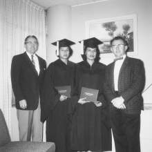  William D. Boehmer and Dr. Stanley Drake, President of Broward Business College, standing with Agnes Johns and Dorothy Osceola in their caps and gowns on graduation day from Broward Business College in Ft. Lauderdale, Florida.